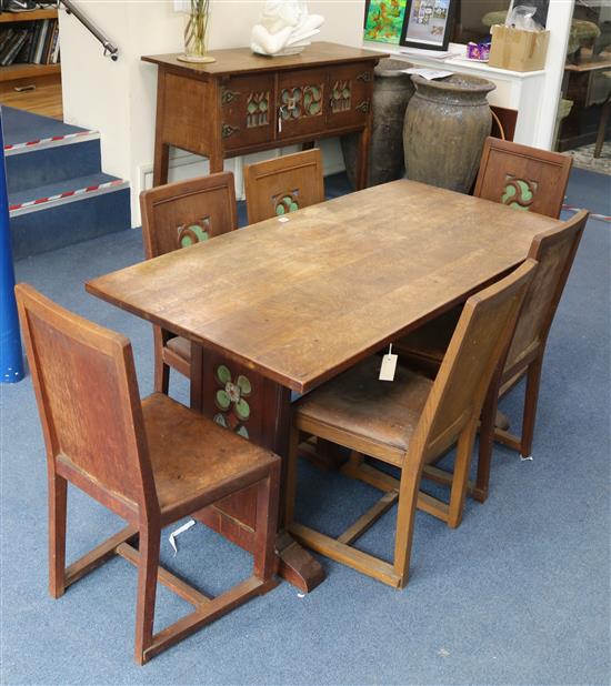 An Arts & Crafts style carved, decorated oak dining suite, comprising refectory table, six chairs and a sideboard Table W.152cm. Sidebo